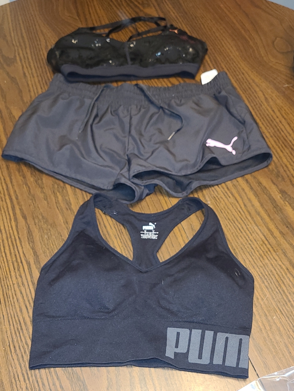 2 Puma Black Sports Bra with Charcoal Shorts and Pink Logo